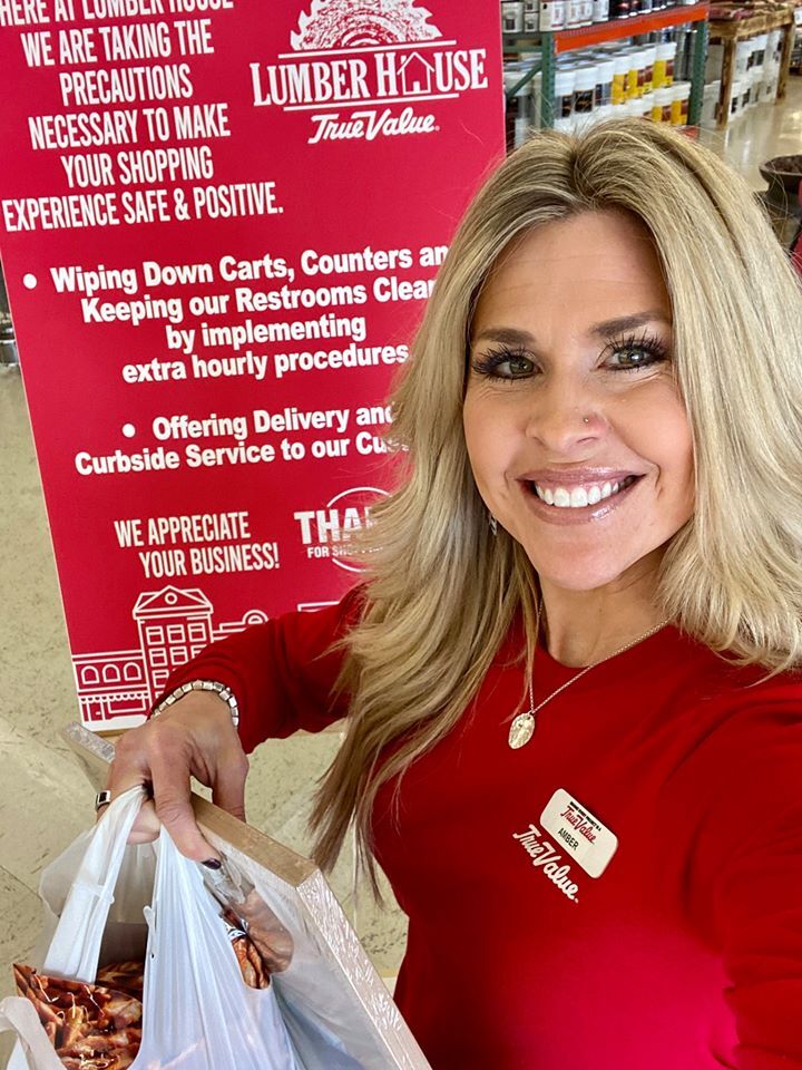 Amber Engle of Lumber House True Value in Abilene, Kan., prepares to take a curbside order out to a customer car.